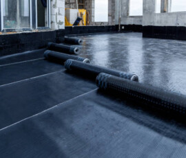Laying and installation of roofing, bituminous waterproofing of an apartment building. Rolled roofing waterproofing of concrete slabs of stylobate. Heating and melting of bituminous roofing material.